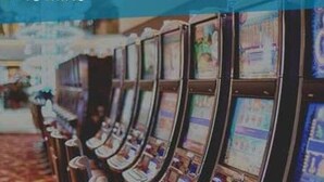 A row of slot machines in a casino setting. - Condo 300 steps from beach with heated pool and private free parking. (Pompano Beach)