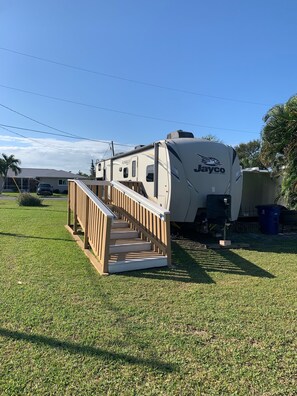 Park your home away from home in this accessible RV, featuring a spacious interior and convenient ramp access.