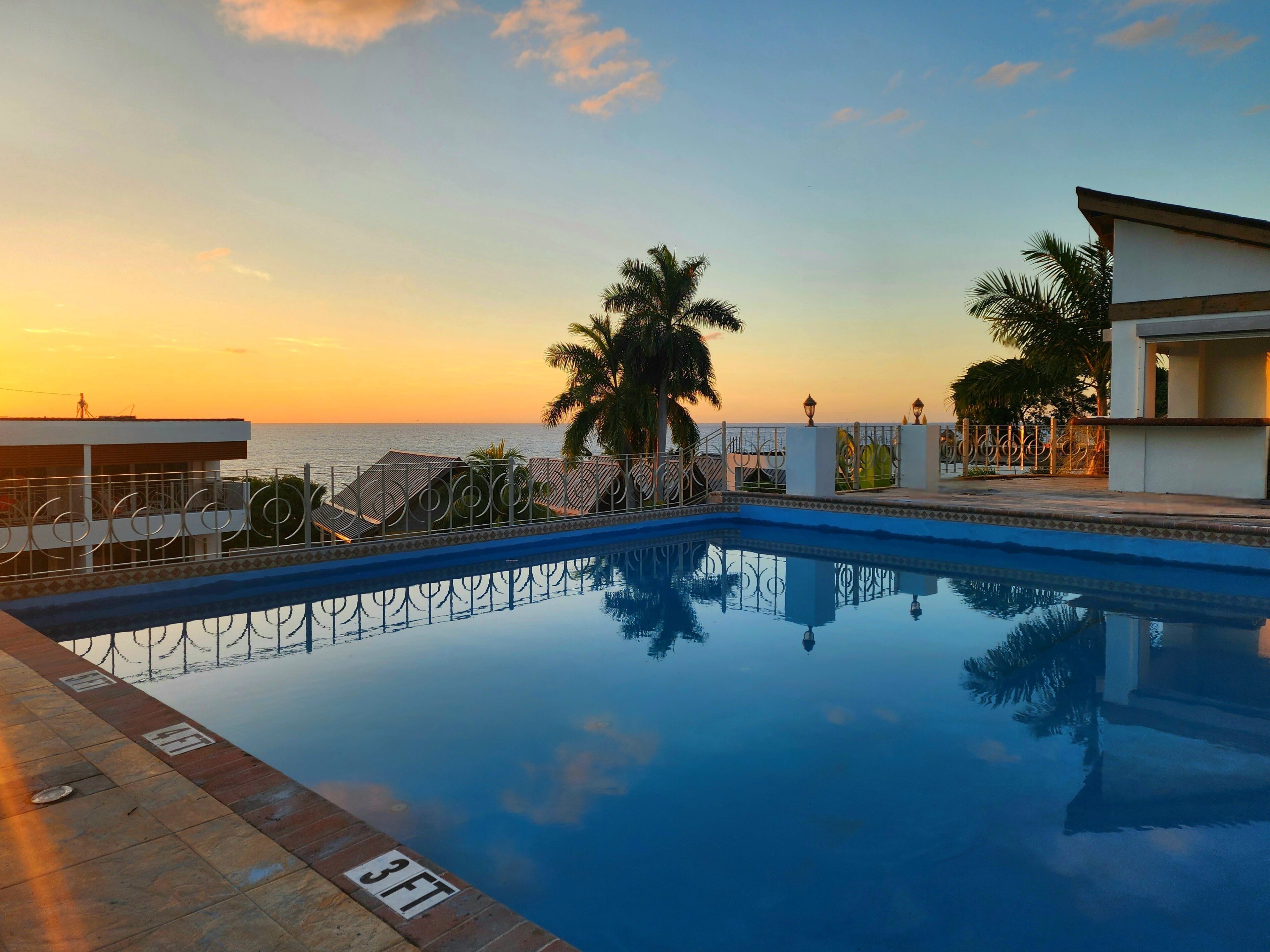 outdoor pool, open 6:00 am to 7:00 pm, pool umbrellas, pool loungers