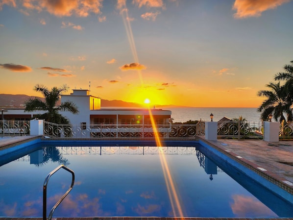 Outdoor pool, open 6:00 AM to 7:00 PM, pool umbrellas, pool loungers
