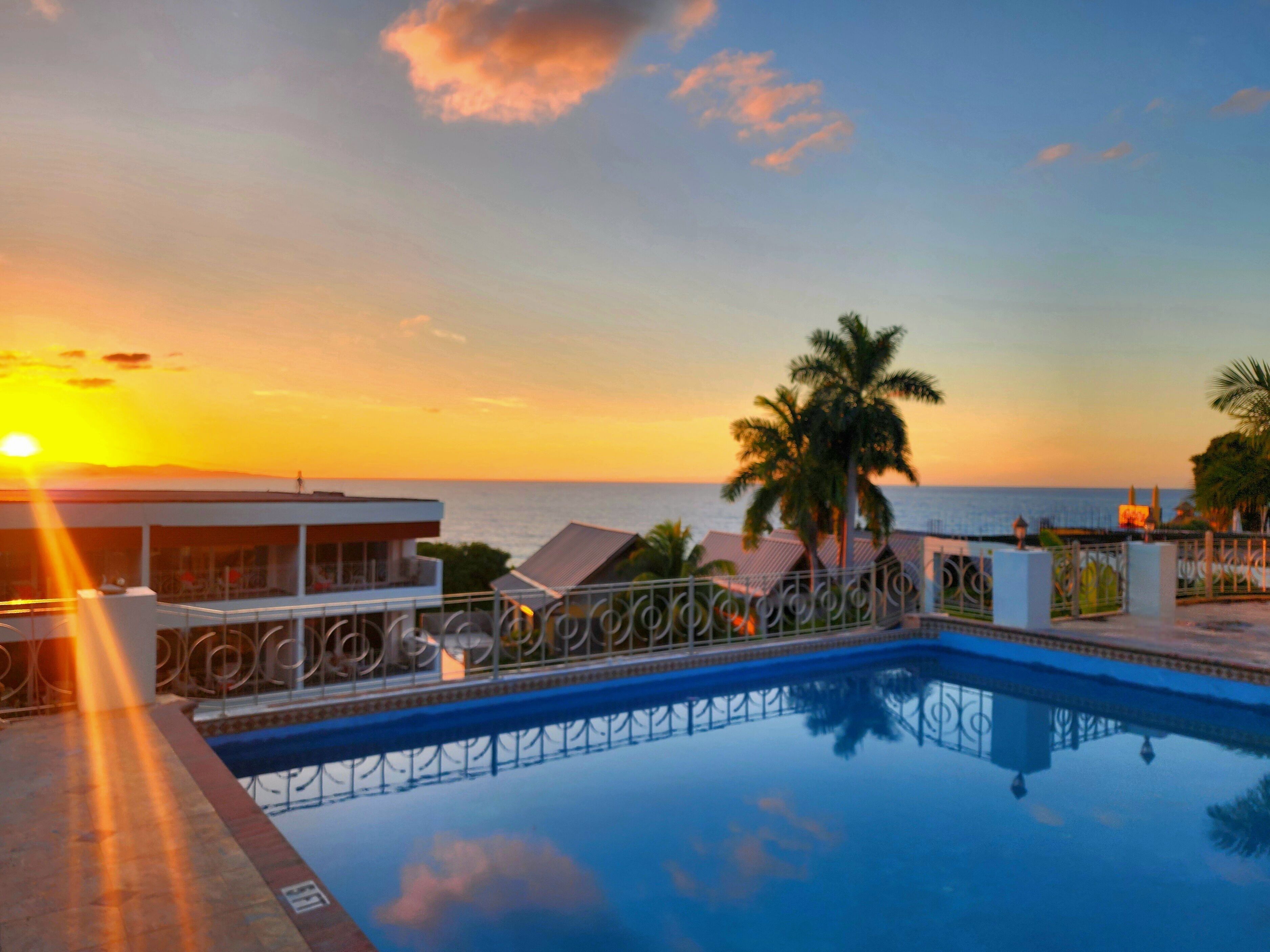 outdoor pool, open 6:00 am to 7:00 pm, pool umbrellas, pool loungers