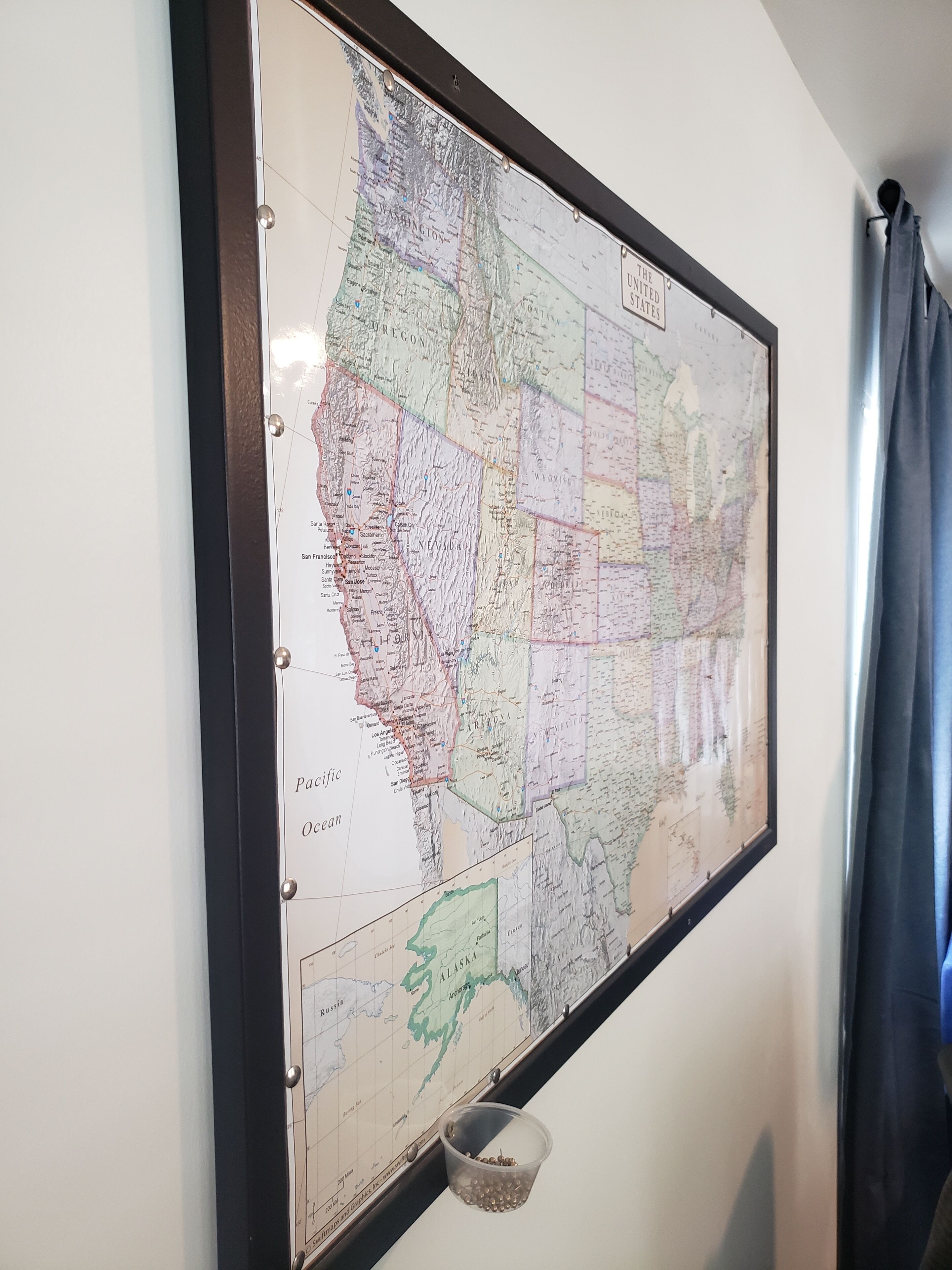 A framed map of the United States on a wall.