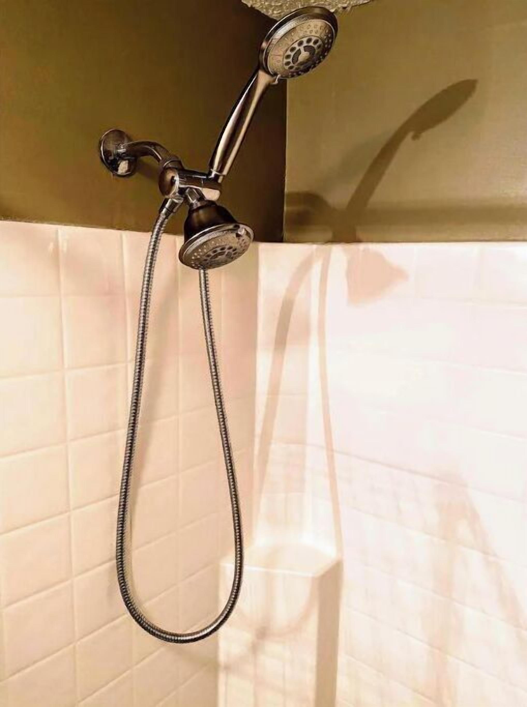A shower with a handheld hose and a wall-mounted showerhead.
