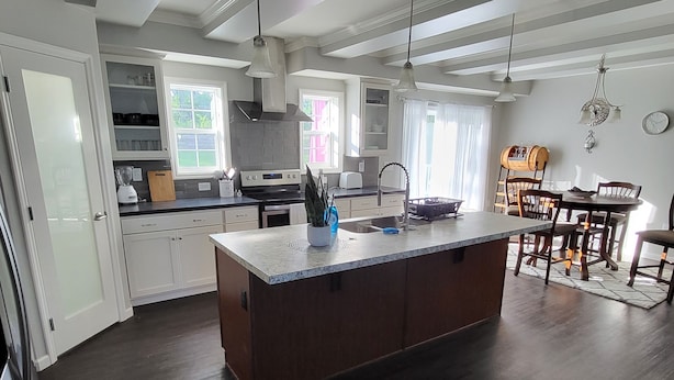 A modern kitchen with a central island, built-in appliances, and ample natural light. - Hillside Relaxation in Endless Mountains. Minutes from Tioga Downs. Sleeps 8 (Rome)