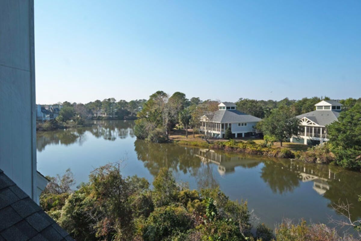 Vista sul lago con una casa e un gazebo.