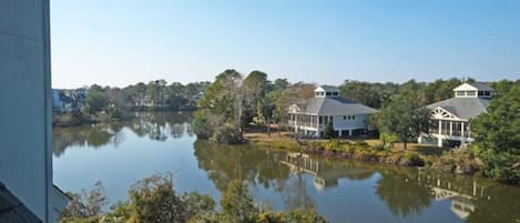 A lakeside view with a house and a gazebo.