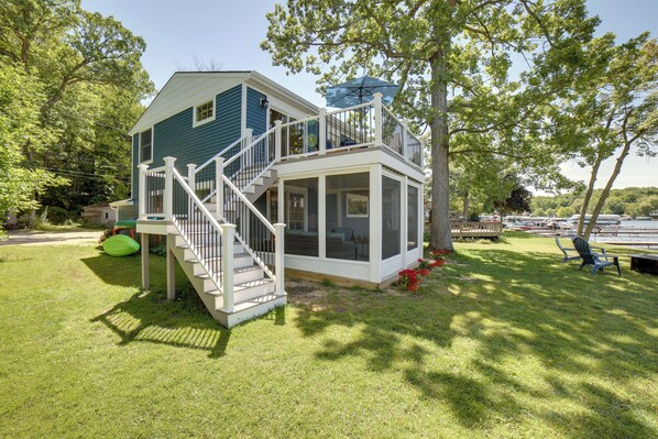 Situated in a residential area, this two-story house offers a covered porch and a spacious balcony.
