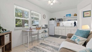 A compact living space with a kitchenette, a dining area, and a seating area with a sofa and a coffee table. - Siesta Keys Neighbor 5min to Beach - Entire Suite Apartment (Sarasota)