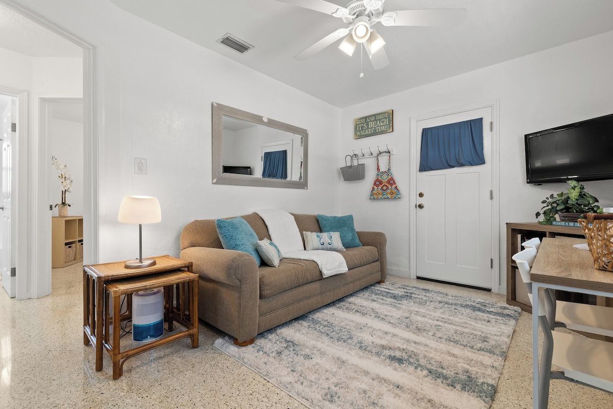 Living room with smart TV and sofa bed.