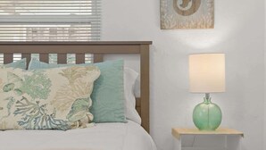 A bedroom with a bed, a bedside lamp, and a wall-mounted artwork. - Siesta Keys Neighbor 5min to Beach - Entire Suite Apartment (Sarasota)