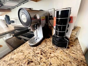 A kitchen with a coffee machine, a sink, and a countertop. - Luxury Loft w/Skylight - Heart of Scott’s Addition (Richmond)