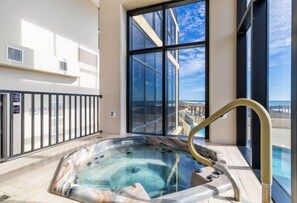 Relax in the hot tub on the ocean-view balcony with a cityscape backdrop.
