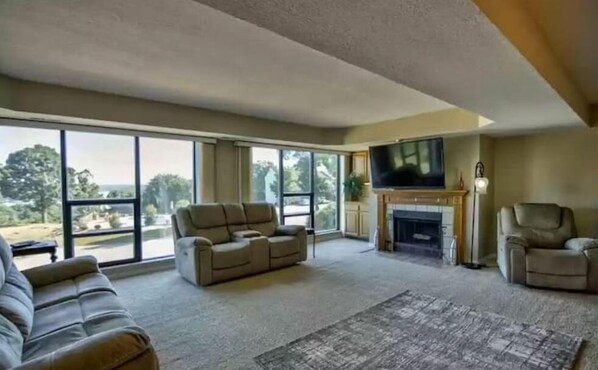 Relax in this cozy living space with a fireplace, flat-screen TV, and comfortable seating area.