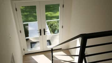 A view from a room to a glass door leading outside.