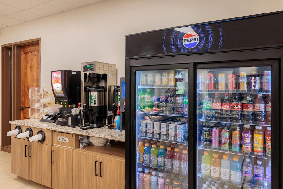 A vending machine with a Pepsi logo, a coffee machine, and a trash bin labeled 'B TRASH.'