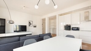 A modern kitchen with white cabinets, a microwave, and an oven. - GuestHost - Bright, brand new Apartment- Milano Centrale (Milano)