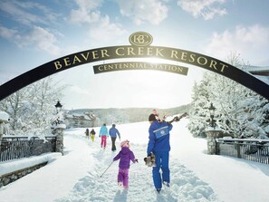 A snowy entrance to Beaver Creek Resort with a sign indicating the Centennial Station. - Charlie Rentz: Ski-In/Out, BC Village, Remodeled Kitchen + AC, Sleeps 6, Walk to Everything (Beaver Creek)