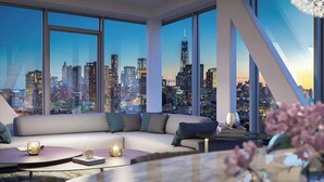 A modern living room with a large window overlooking a city skyline at dusk. - Travive Brand New Four Bedroom Penthouse (New York)