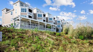 A multi-story hotel with balconies and a covered walkway. - Point of View by SoCharm | Luxury Lakefront Condo | Deck | Sleep 6 (Mooresville)