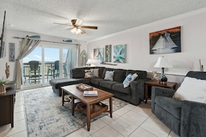A living room with a sofa, coffee table, and a ceiling fan. - La Mirage Condo 220 Beachfront Resort Condominiums with Private Boardwalk (Port Aransas)