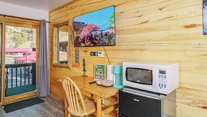 A wooden interior with a television, microwave, and a small refrigerator. - pacious Upper-Level Hotel Queen and Full-size beds with Views 208-210 (Estes Park)