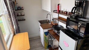 A compact kitchen with a built-in microwave, a coffee maker, and a toaster. - Relax and still be close enough to the Newport Scene. (Portsmouth)