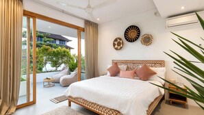 Un dormitorio con una cama grande, ventilador de techo y vistas al exterior.