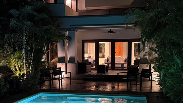 A swimming pool with a deck area, surrounded by tropical plants. - Villa Zafiro: Luxurious private villa & pool - steps from gorgeous beaches! (Playa Langosta)