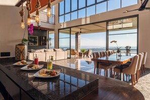 Enjoy a modern kitchen with a large island countertop, bathtub, and ocean views.