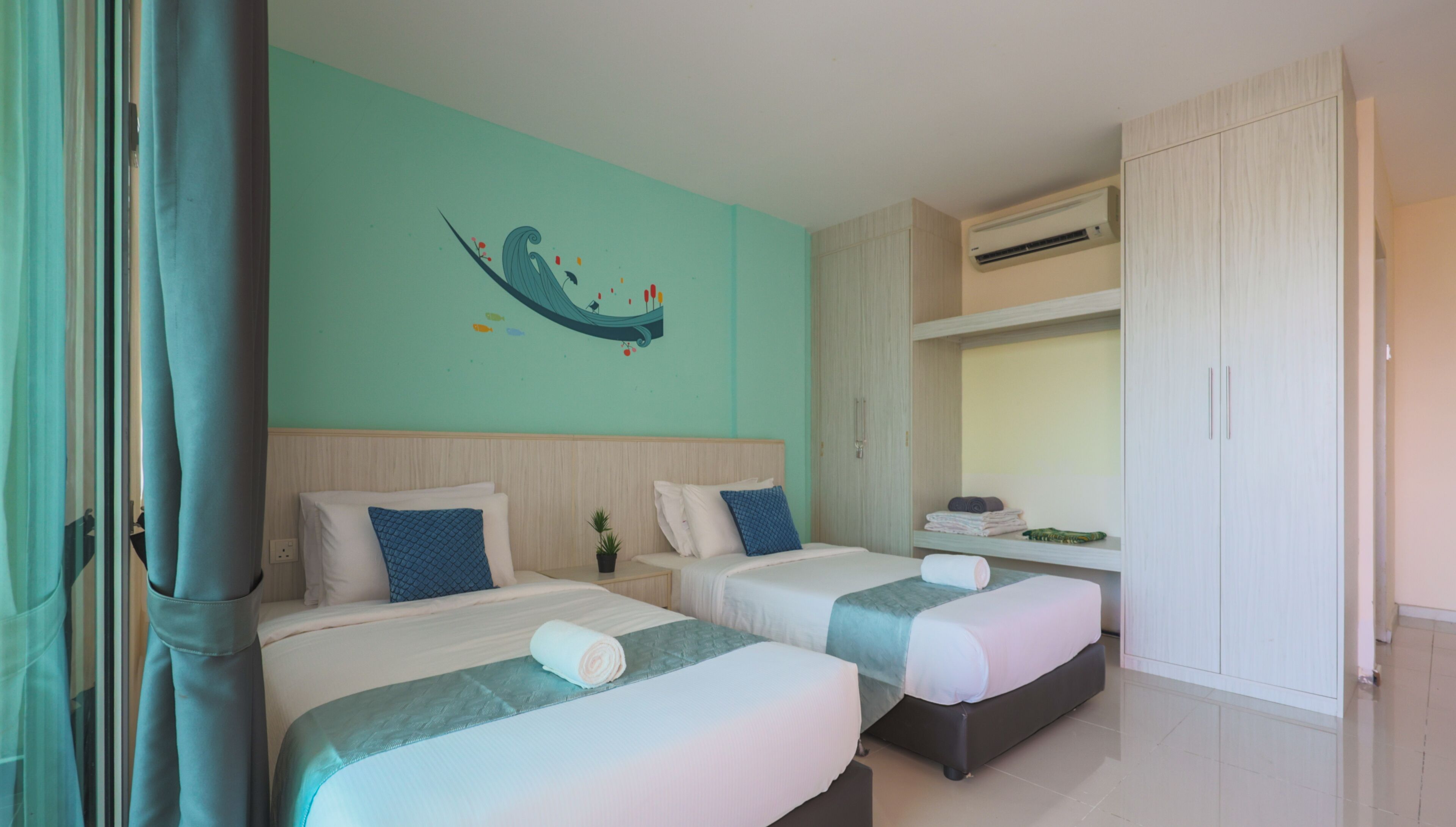 A hotel room with two beds, a wall mural, an air conditioning unit, and a wardrobe.