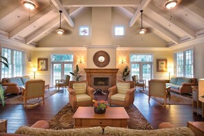 A spacious living room with a fireplace, comfortable seating, and large windows. - Wyndham Kingstown Reef | 4BR King Suite w Balcony (Orlando)