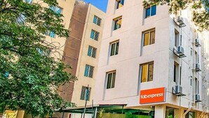 A multi-story building with a 'Fabexpress' sign on the ground floor, indicating a commercial space. - Fabexpress A1 Dalcha (Pune)