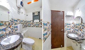 A bathroom with a marble sink, toilet, and shower. The walls are tiled with a geometric pattern. - Fabhotel Anchorage Inn (Barasat)