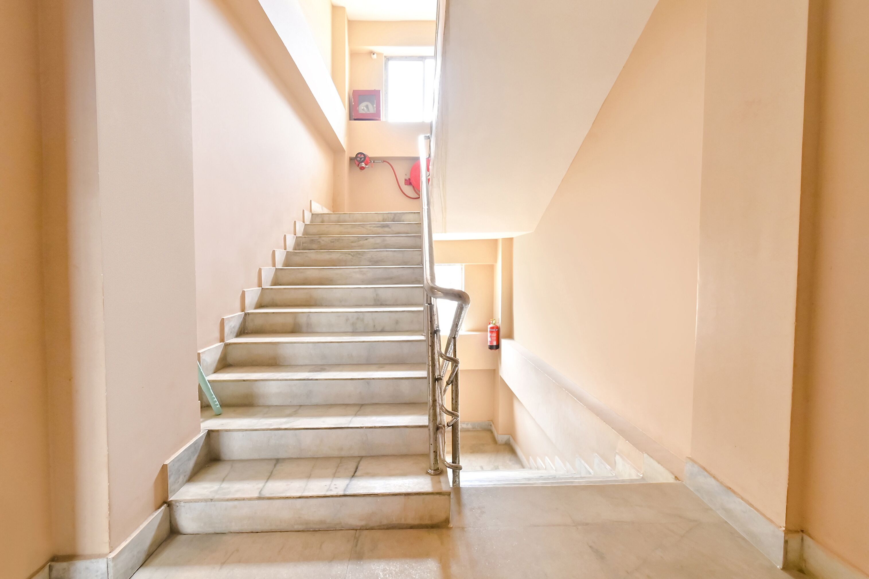 A staircase with a handrail leading to a landing.