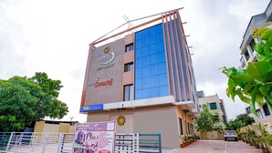 A hotel with a modern facade, a prominent sign for Hotel Swara, and a gated entrance. - Fabhotel Swaraj (Palghar)