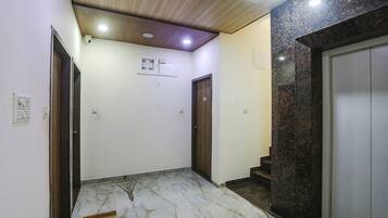 A hallway with a marble floor, a ceiling fan, and a door with the number 304.