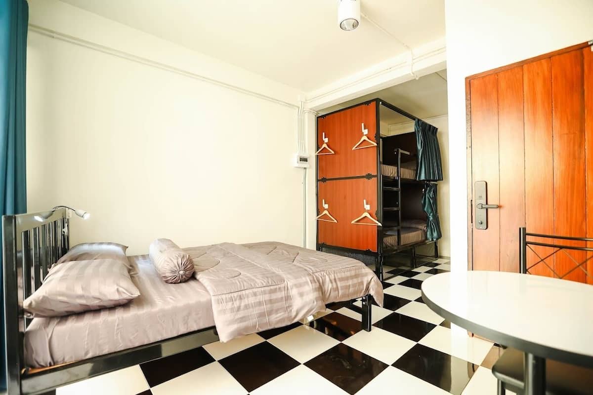 A room with a bed, a table, and a wardrobe.