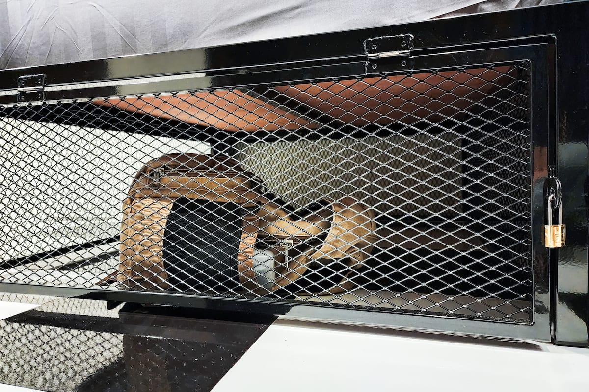 A vehicle with a metal cage and a padlock.