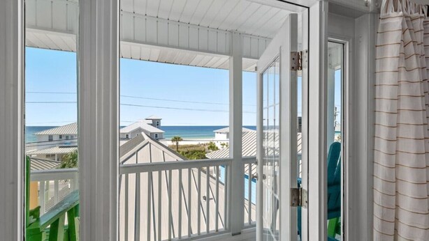 A balcony with a view of the beach and ocean. - Sea-Jay ~ Dog-Friendly Gulf View Retreat, Steps to Beach & Pier Park (Panama City Beach)