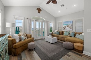 A spacious living room with two sofas, a coffee table, and a fireplace.