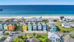 A coastal residential area with colorful houses, a beach, and a pier. - Sea-Jay ~ Dog-Friendly Gulf View Retreat, Steps to Beach & Pier Park (Panama City Beach)
