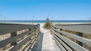 A wooden boardwalk leading to a beach with clear skies. - Sea-Jay ~ Dog-Friendly Gulf View Retreat, Steps to Beach & Pier Park (Panama City Beach)