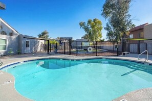 Relax by the rectangular pool with a central feature.