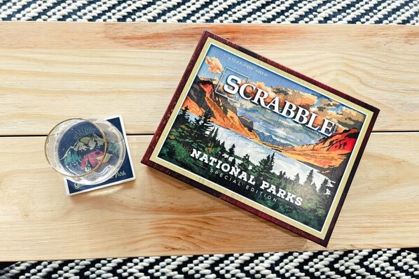 A Scrabble board game titled "National Parks Special Edition" on a wooden surface.
