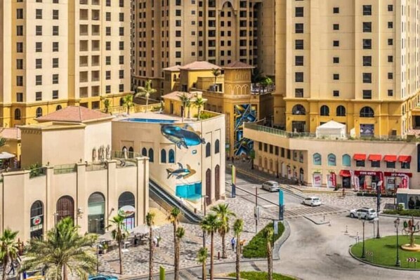 A high-rise hotel with multiple floors, a central courtyard, and a swimming pool.