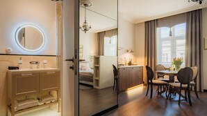 Une chambre d’hôtel moderne comprenant une salle de bain, un coin repas et une chambre à coucher.