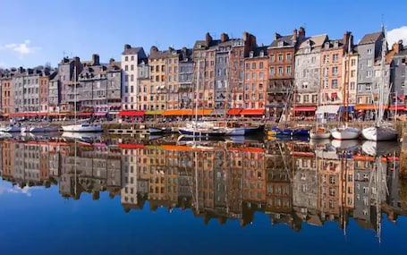 A waterfront with historic buildings and boats docked.