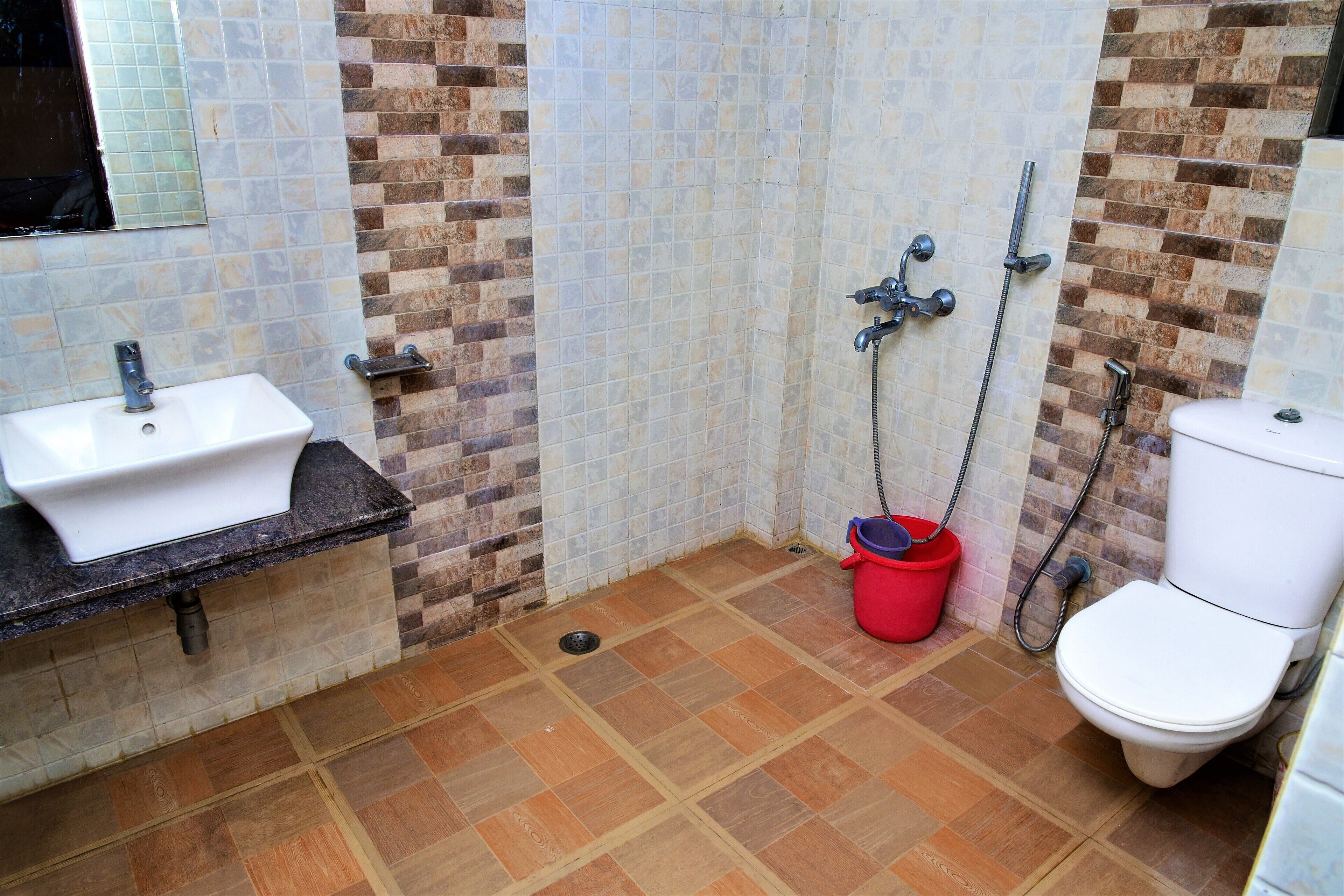 A bathroom with a sink, toilet, and shower.