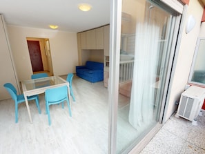 Enjoy a compact living space with a balcony, dining area, and cozy seating.