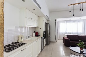 Enjoy a well-equipped kitchen with a gas stove, refrigerator, and ample dining space.